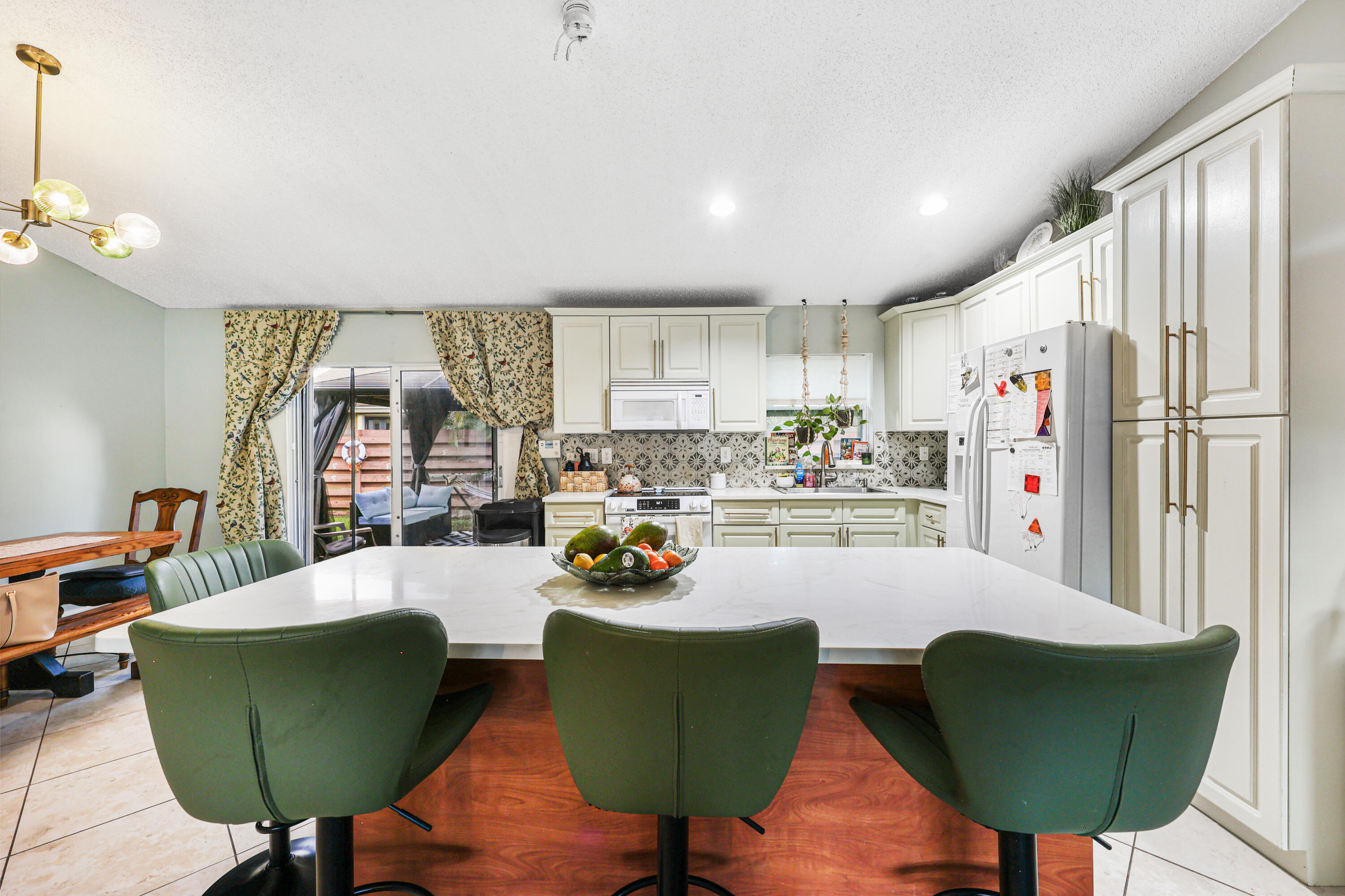 7527 Southwest 7th Street North Lauderdale, FL 33068 - Photo 23 of 34 a living room with furniture and a chandelier