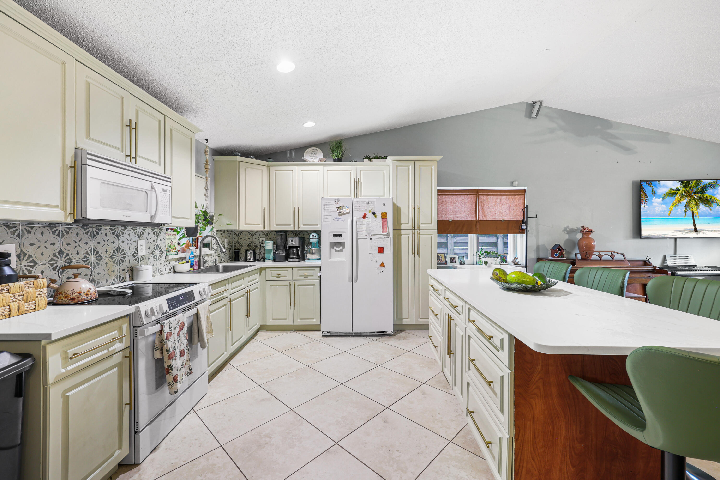7527 Southwest 7th Street North Lauderdale, FL 33068 - Photo 24 of 34 a kitchen with a sink a refrigerator and cabinets