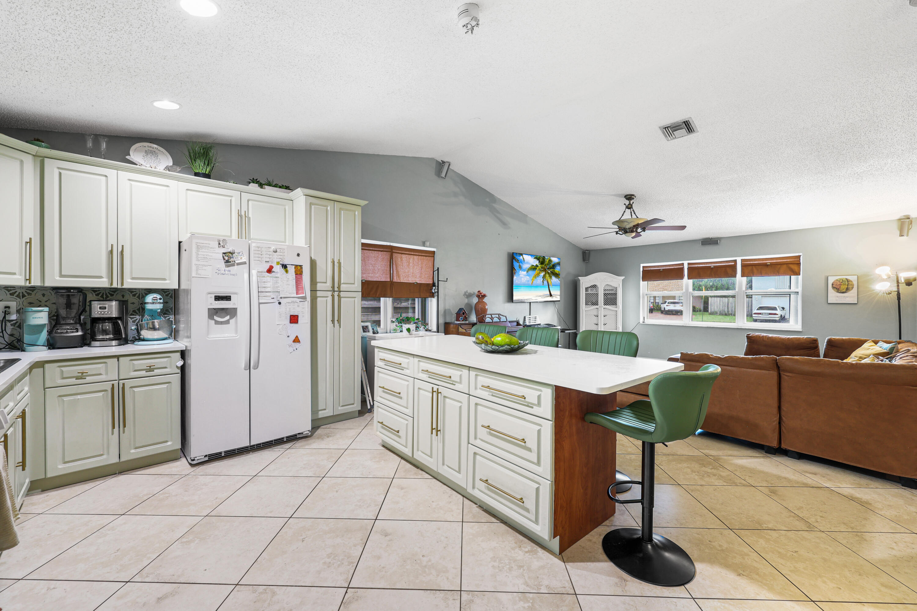 7527 Southwest 7th Street North Lauderdale, FL 33068 - Photo 25 of 34 a kitchen with stainless steel appliances kitchen island granite countertop a sink and cabinets