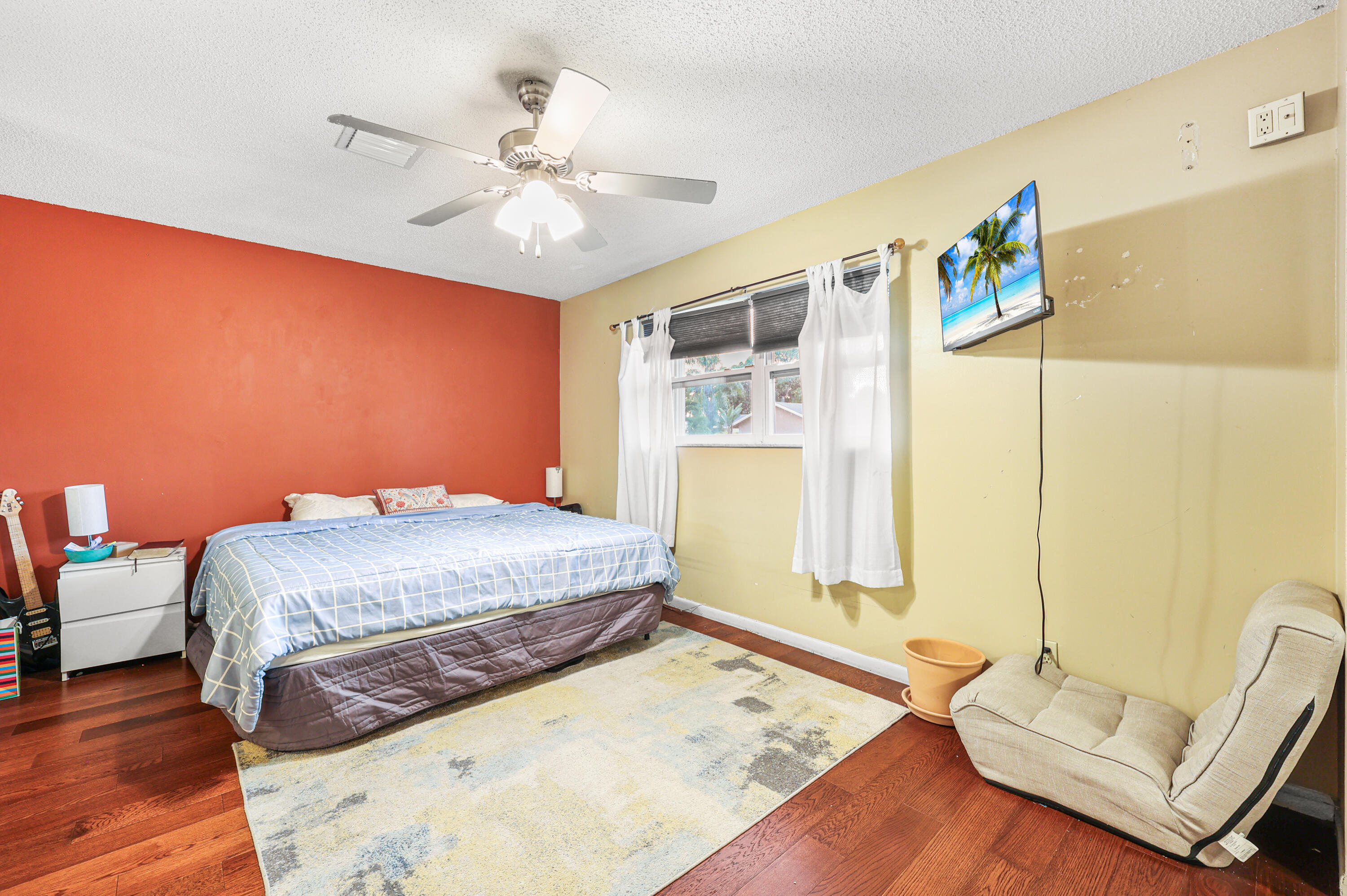 7527 Southwest 7th Street North Lauderdale, FL 33068 - Photo 6 of 34 a bedroom with a bed and a chandelier