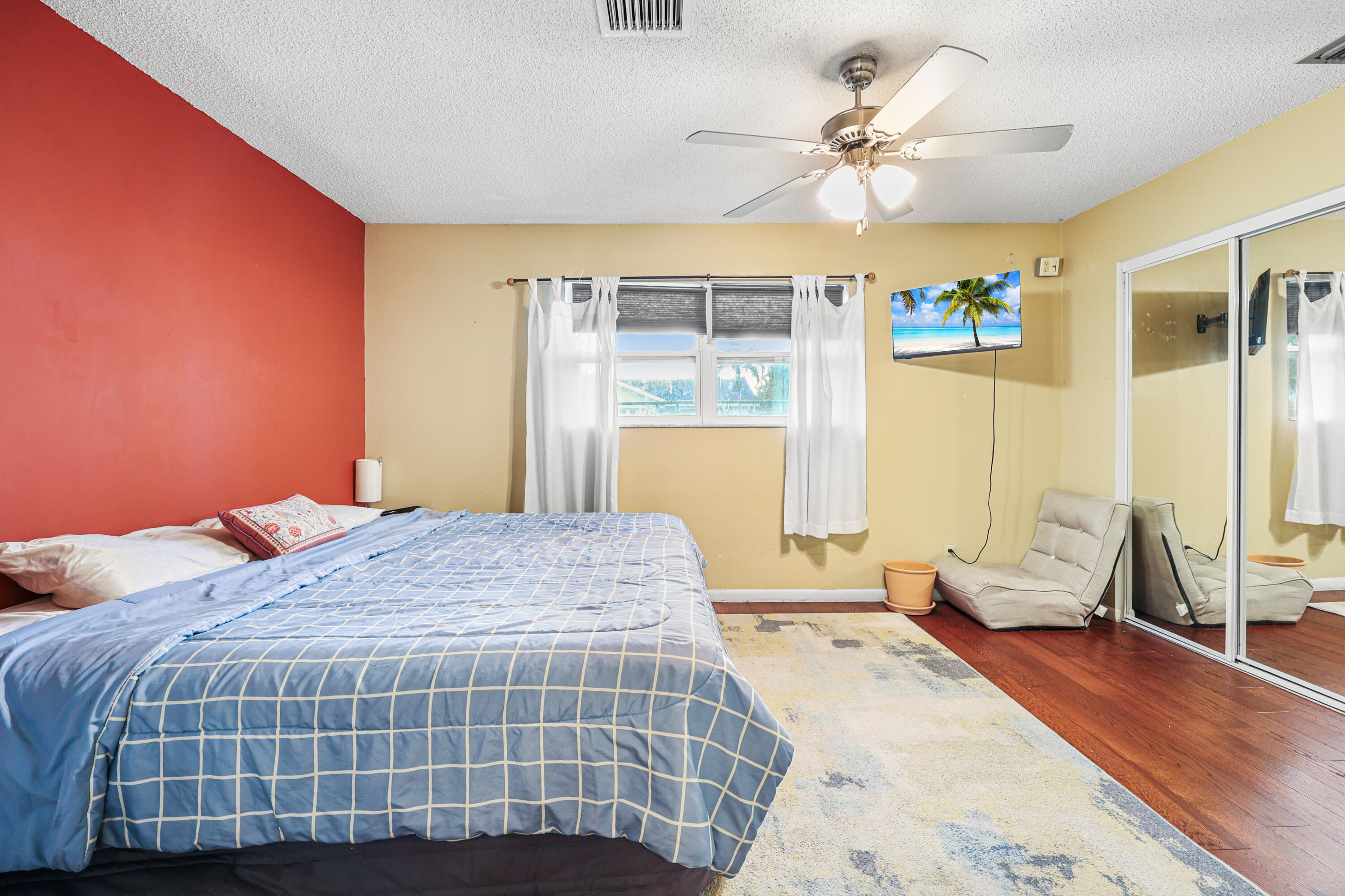7527 Southwest 7th Street North Lauderdale, FL 33068 - Photo 10 of 34 a bedroom with a large bed and a chandelier