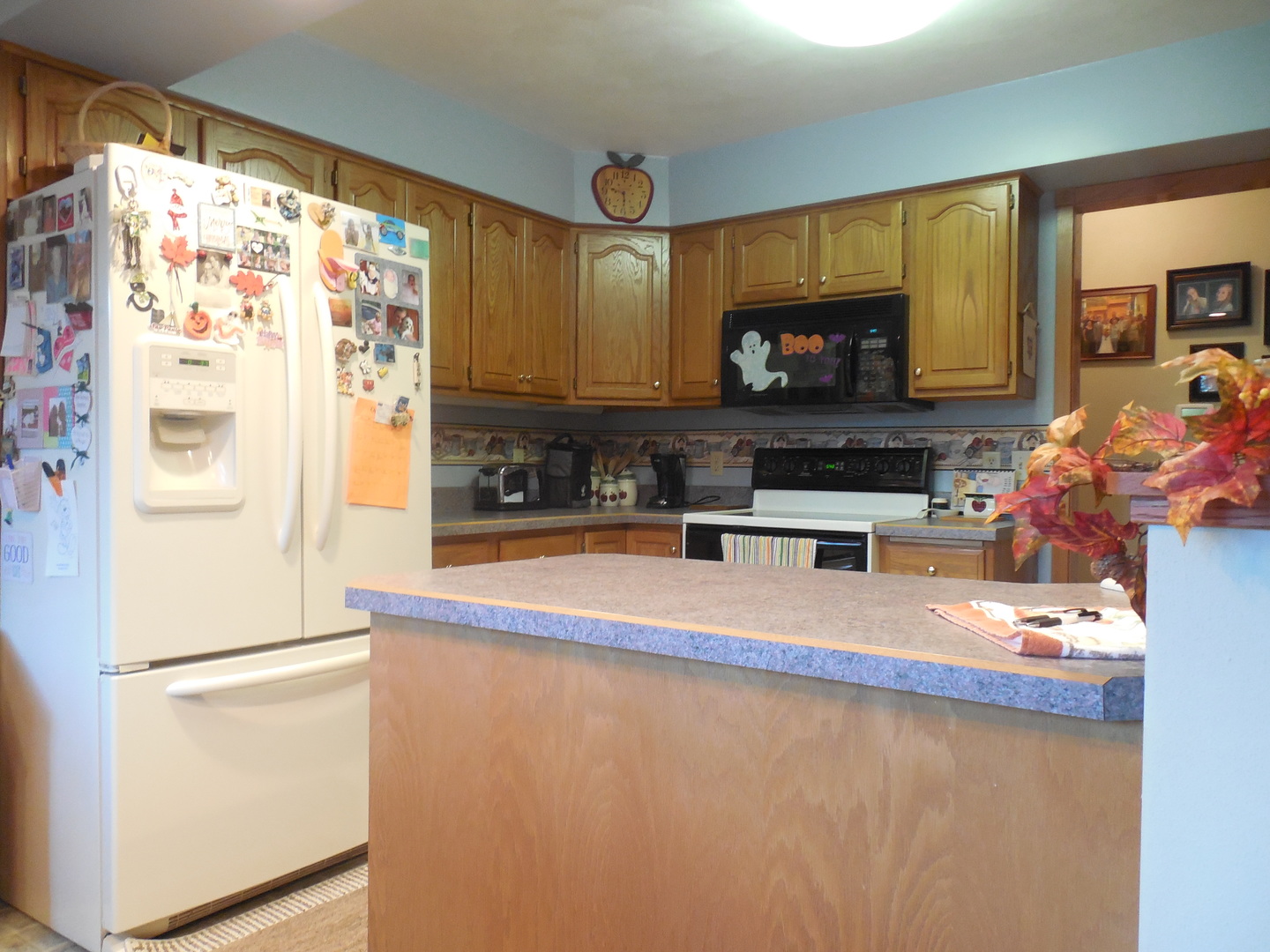 6472 Penrose Road Fulton, IL 61252 - Photo 3 of 21 a kitchen with stainless steel appliances a refrigerator a stove a microwave and cabinets