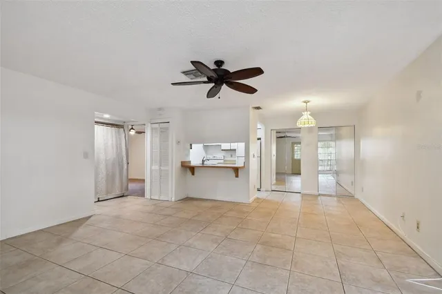 a view of a livingroom with a ceiling fan and window