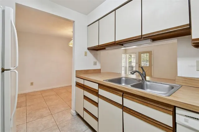 a view of a big room with chandelier fan and a bathroom