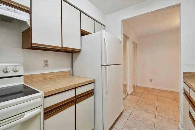 an empty room with chandelier fan