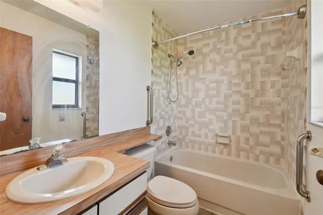 an empty room with closet and a chandelier fan