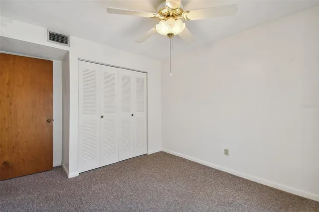 a tree in front of a white house