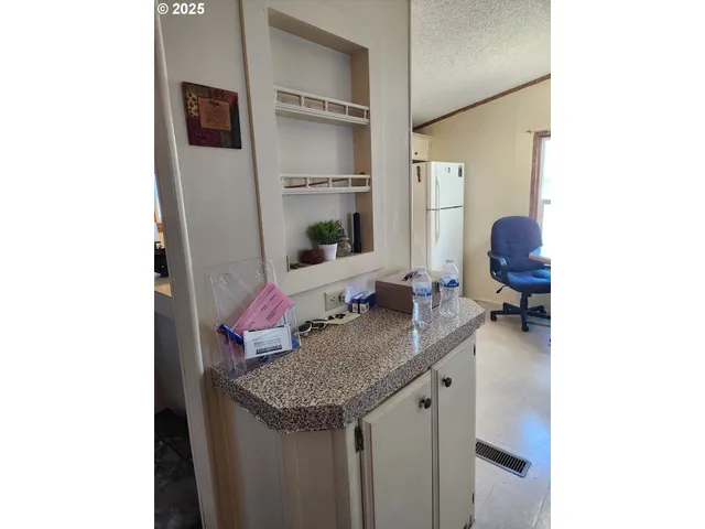 a kitchen with a sink and a refrigerator