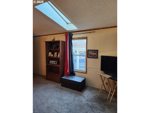 a living room with furniture and large window