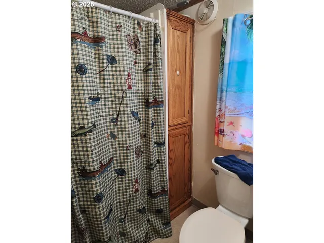 a bathroom with a toilet and shower