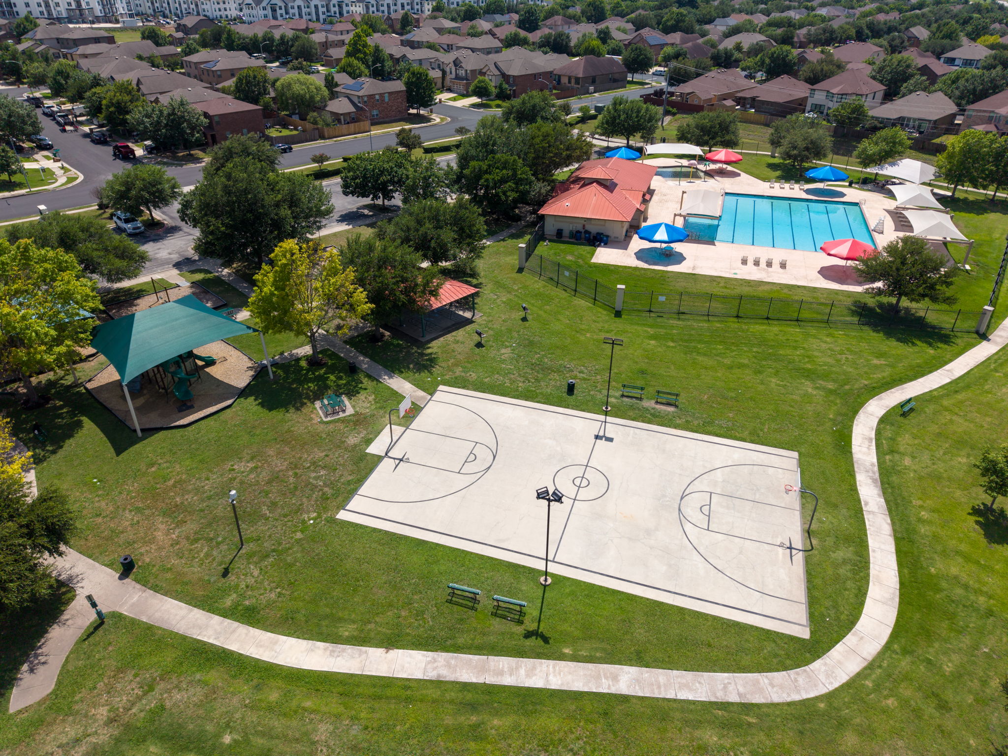 8813 Wiley Way Austin, TX 78747 - Photo 34 of 39 A vibrant community park with recreational amenities, including a refreshing pool and a sports court.