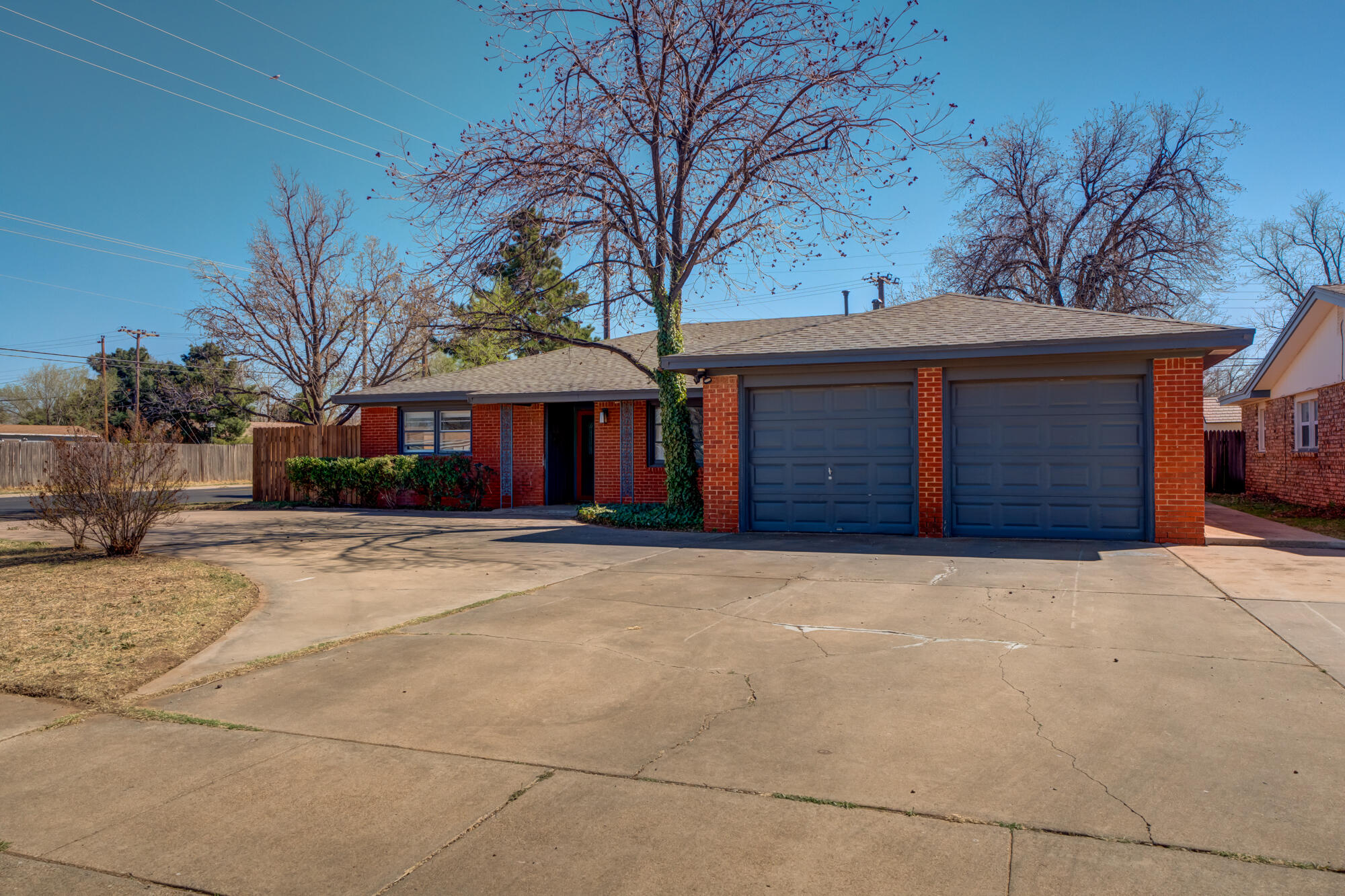2101 64th Street Lubbock, TX 79412 - Photo 1 of 30 a front view of a house with a yard and garage