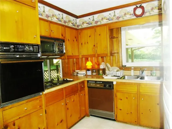 a kitchen with stainless steel appliances granite countertop a sink and cabinets