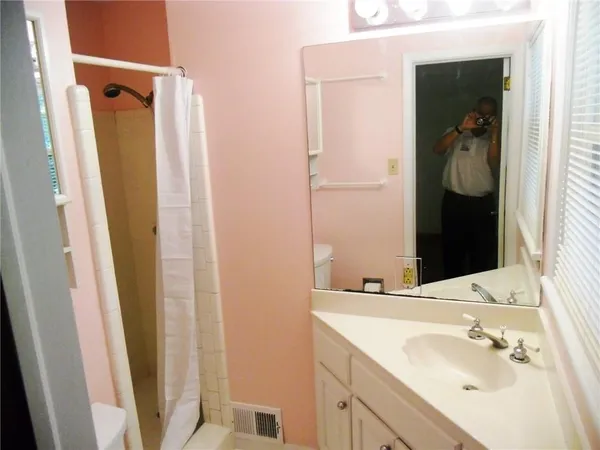 a bathroom with a sink vanity and a mirror