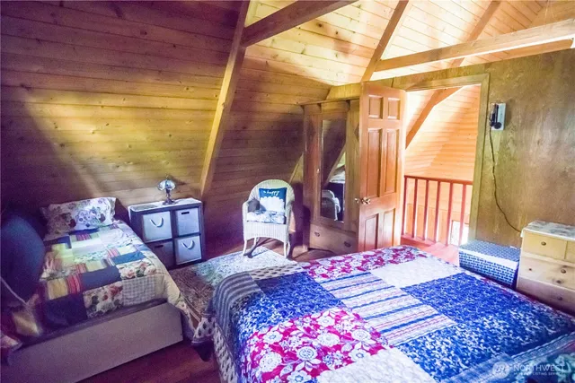 a room with a bed and a mirror on the dresser