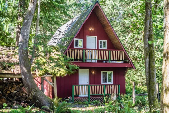 a view of a house with balcony and trees