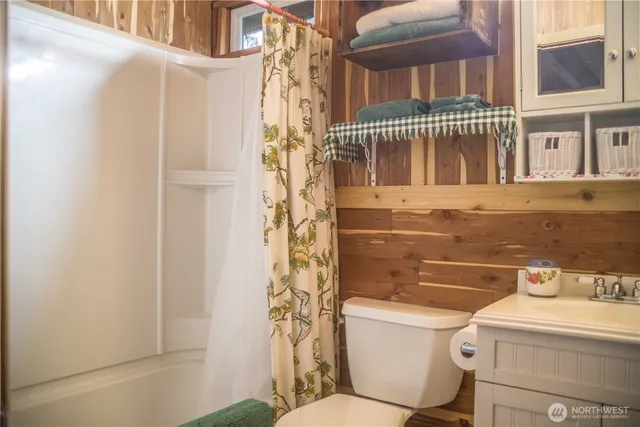 an aerial view of a house with a yard and large trees