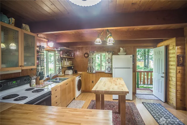 a view of a dining room with furniture wooden floor and a chandelier