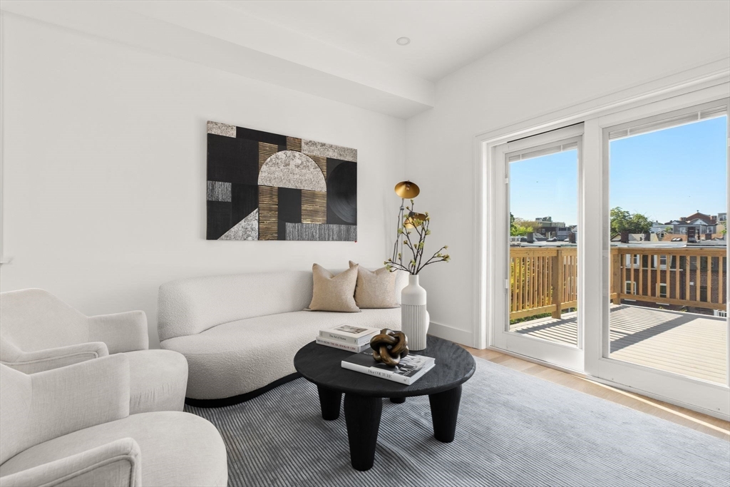 100 Bennington Street, Unit PH4A Boston, MA 02128 - Photo 13 of 41 a living room with furniture and a floor to ceiling window
