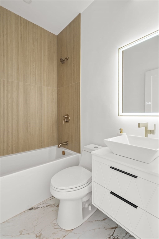 100 Bennington Street, Unit PH4A Boston, MA 02128 - Photo 38 of 41 a bathroom with a toilet a sink a mirror a bathtub and vanity