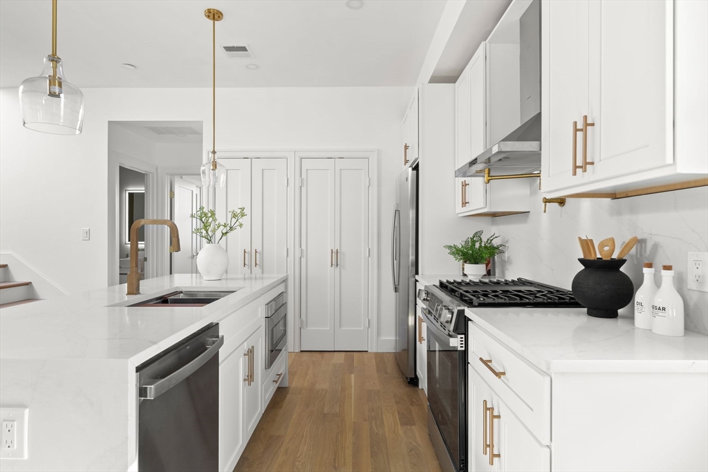 100 Bennington Street, Unit PH4A Boston, MA 02128 - Photo 6 of 41 a kitchen with a sink and stove