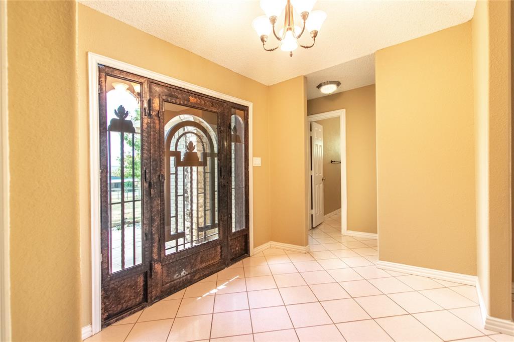 308 Sanders Road Denton, TX 76210 - Photo 8 of 31 Wrought iron front door with arched glass panels, side lights, and transom window