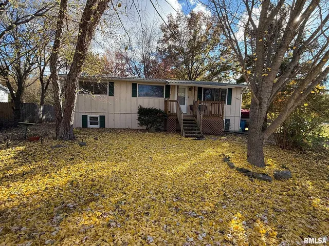 a view of a house with a yard and trees