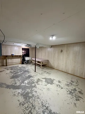 a view of kitchen with refrigerator and wooden floor