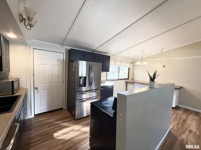 a kitchen with refrigerator and cabinets