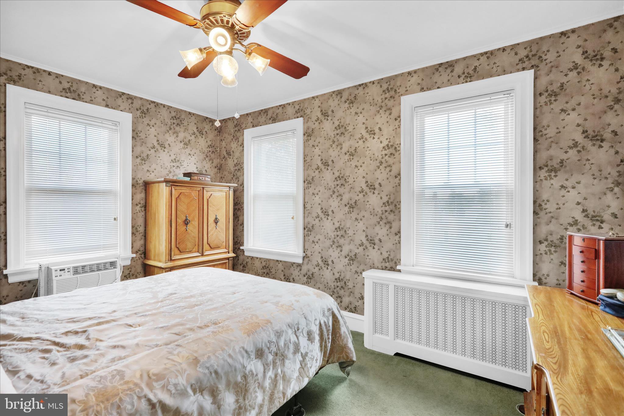 21 Woodland Road Reading, PA 19610 - Photo 13 of 39 a bedroom with a bed and a chandelier