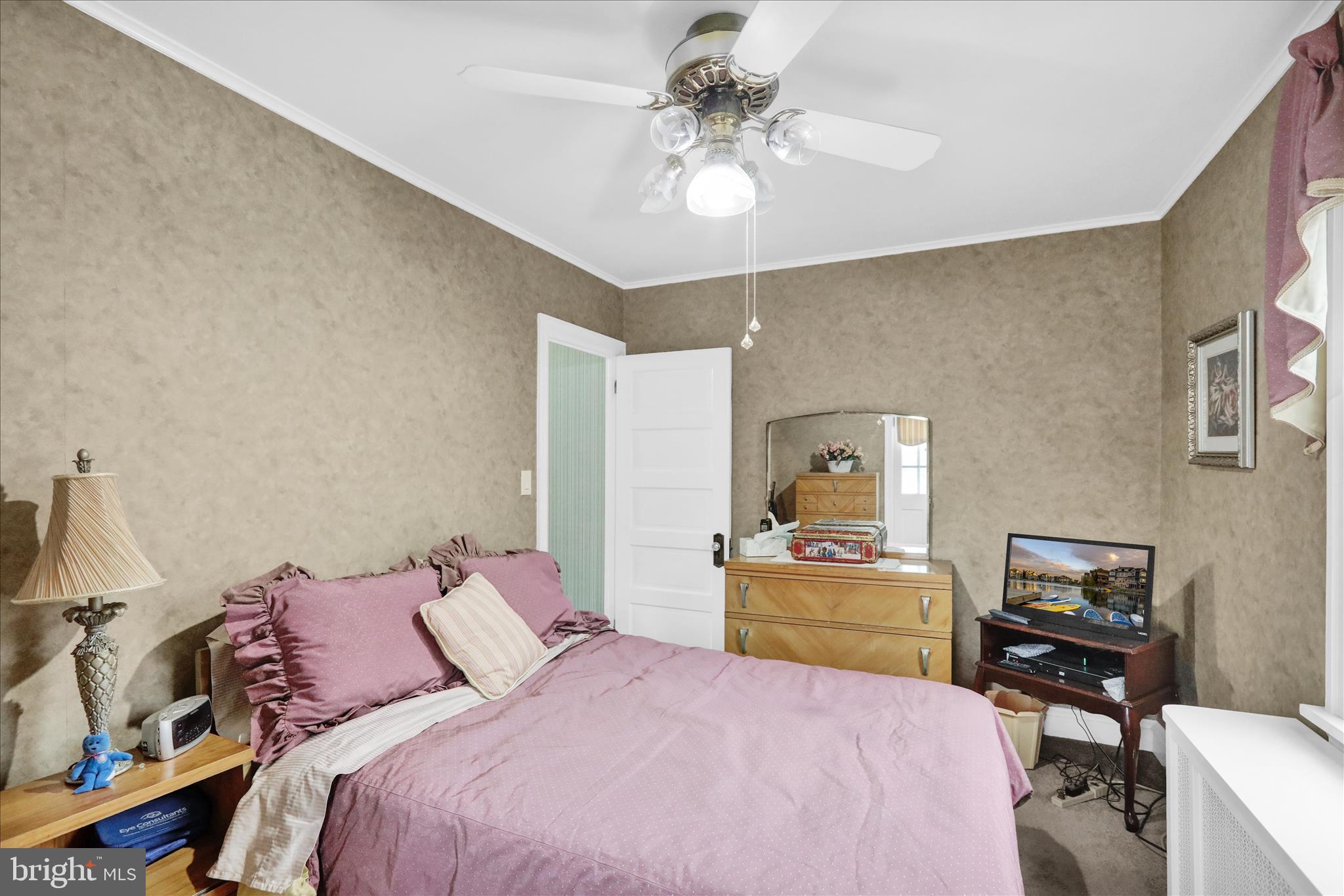 21 Woodland Road Reading, PA 19610 - Photo 19 of 39 a bedroom with a bed and a chandelier