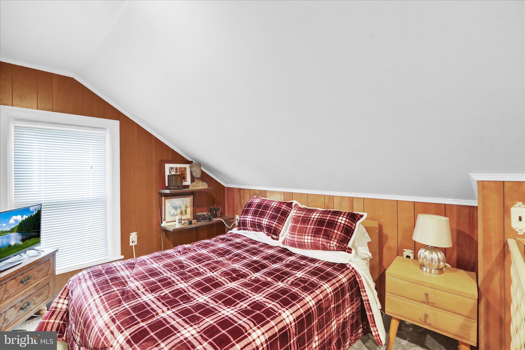 21 Woodland Road Reading, PA 19610 - Photo 20 of 39 a bedroom with a bed and a lamp with the dresser