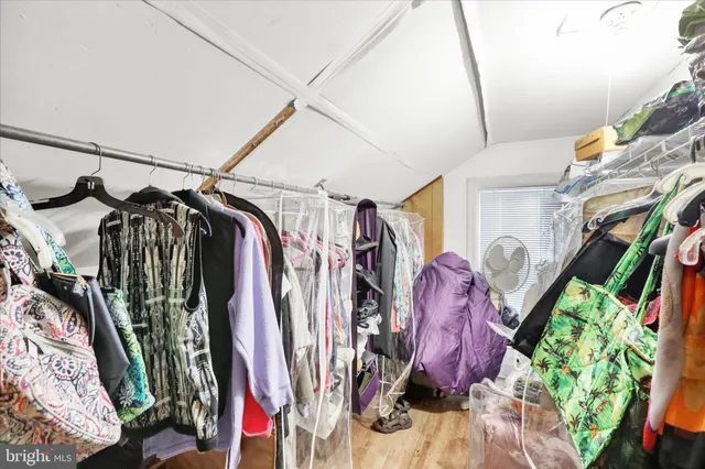 a view of walk in closet with clothes