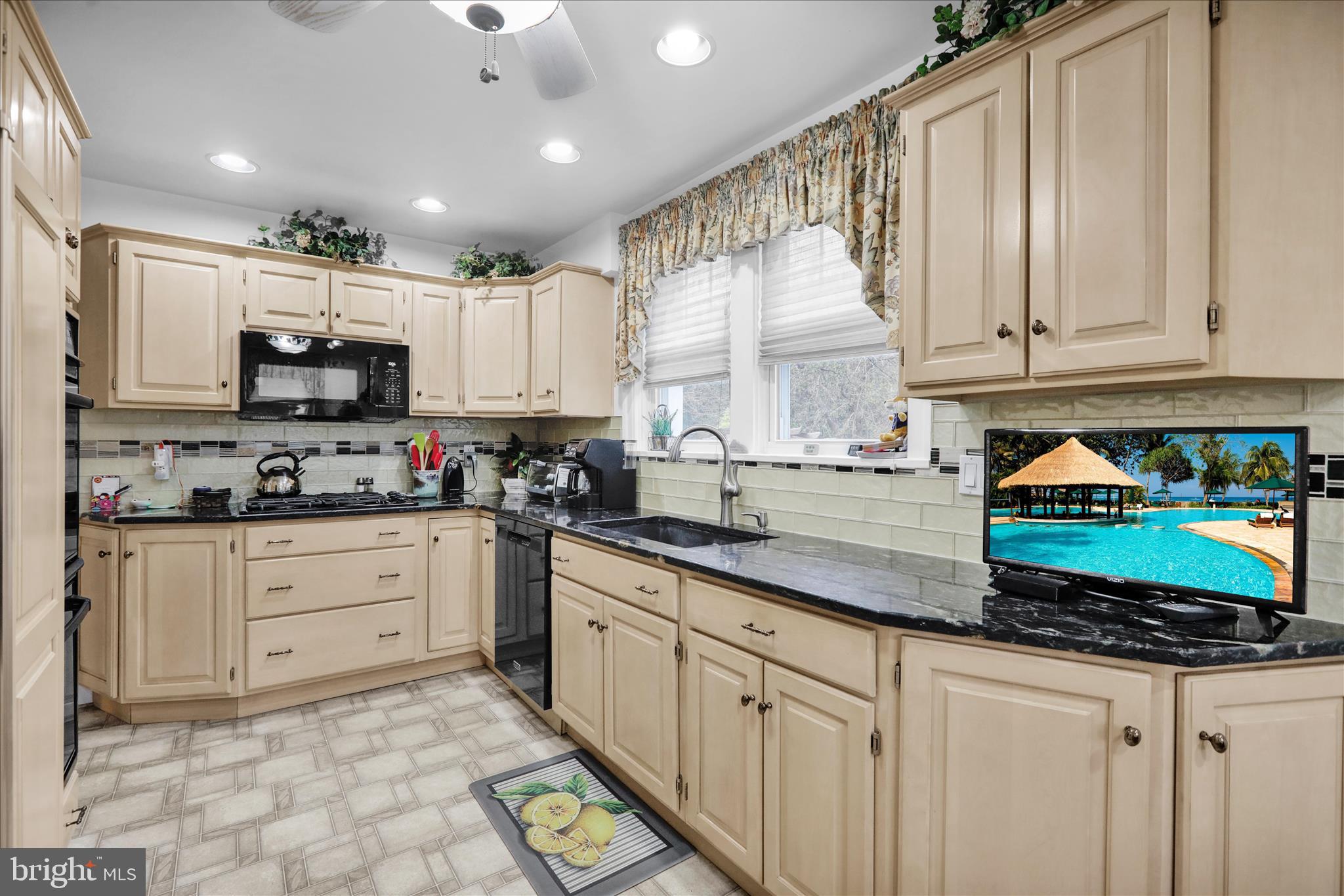 21 Woodland Road Reading, PA 19610 - Photo 3 of 39 a kitchen with stainless steel appliances granite countertop a stove a sink and white cabinets