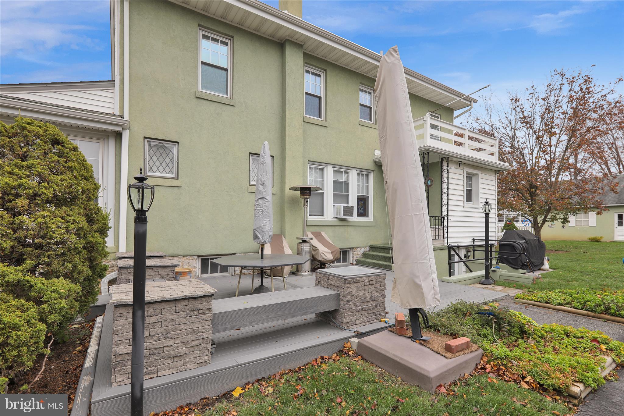 21 Woodland Road Reading, PA 19610 - Photo 38 of 39 a view of a patio with couches table and chairs with wooden fence and plants