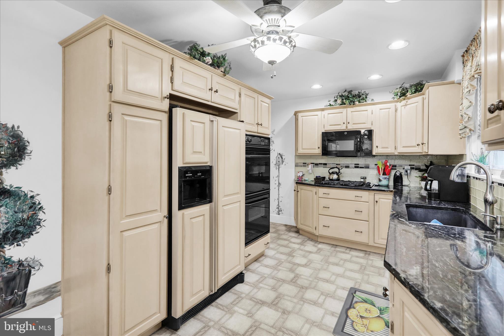 21 Woodland Road Reading, PA 19610 - Photo 4 of 39 a kitchen with stainless steel appliances a refrigerator sink and microwave