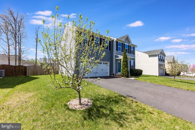 2082 Mallard Lane Locust Grove, VA 22508 - Photo 2 of 32 a backyard of a house with a yard and outdoor seating