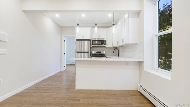 a kitchen with kitchen island a sink appliances and cabinets