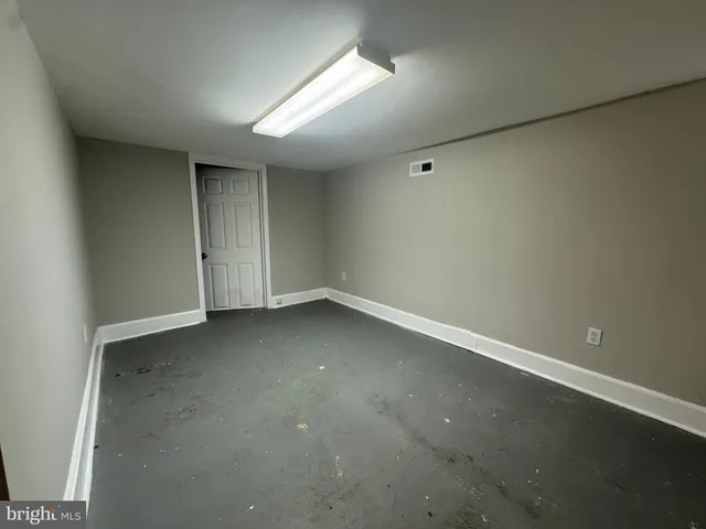 an empty room with a empty space and windows