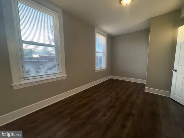 a view of an empty room and wooden floor