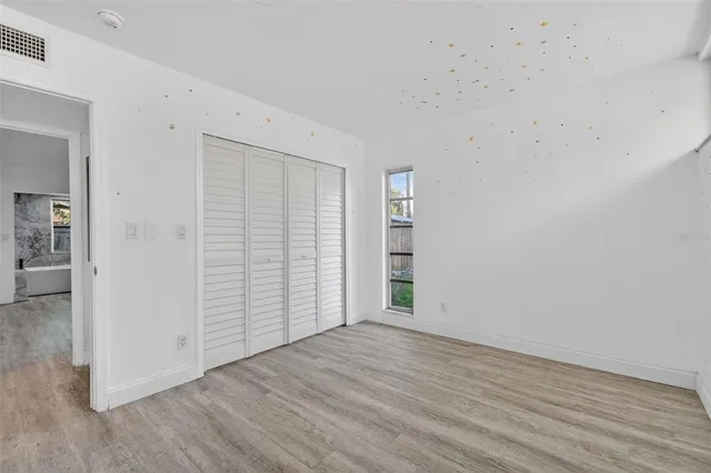 a view of entryway with a white wall and a shower