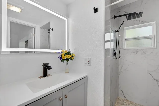 a view of an empty room with a window and a ceiling fan