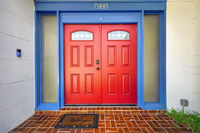 a view of a hallway with wooden floor and a potted plant