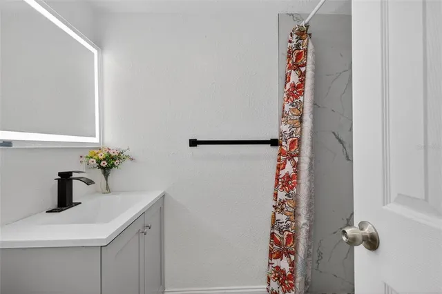 a view of kitchen and hall with wooden floor