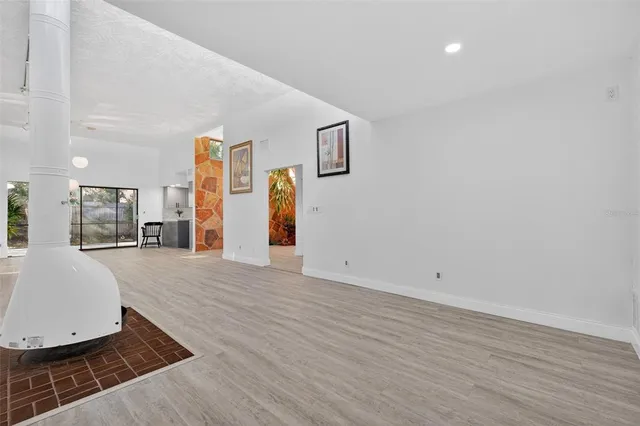 a kitchen with granite countertop white cabinets and stainless steel appliances