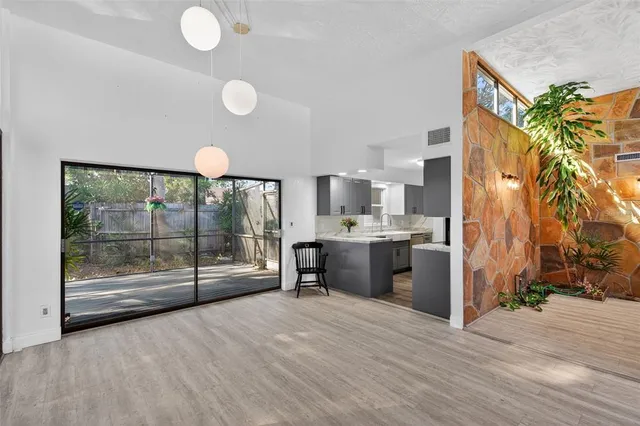 a view of a granite countertop kitchen with a sink and large window