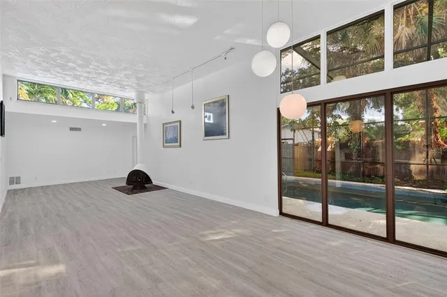 a view of a swimming pool with a patio and a yard