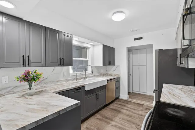 a living room with patio furniture and a floor to ceiling window