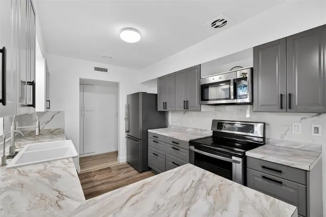 a backyard of a house with barbeque oven table and chairs
