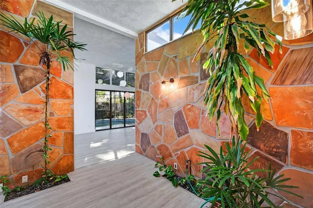 a view of an empty room with wooden floor and closet